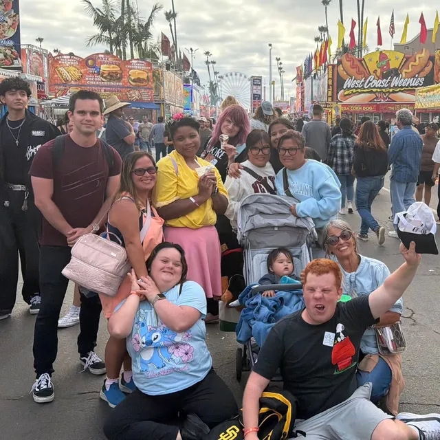 A big group of friends smiling together at the county fair