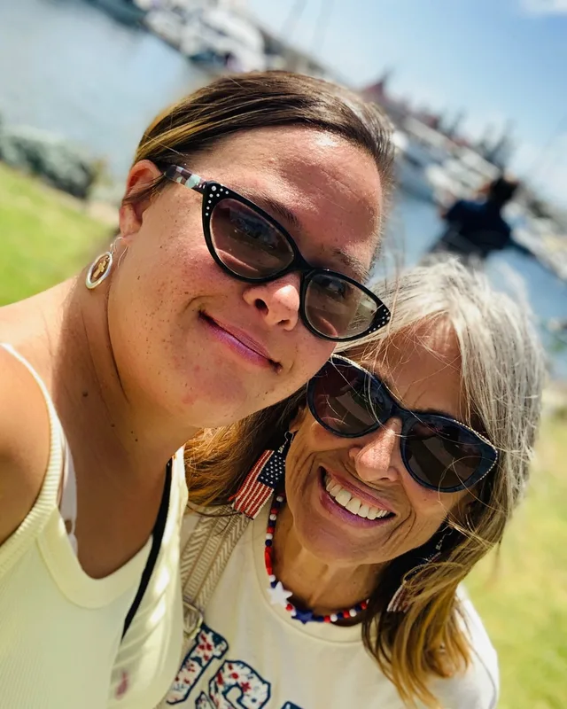 Laura and her daughter Jasmine taking a sunny selfie by the harbor