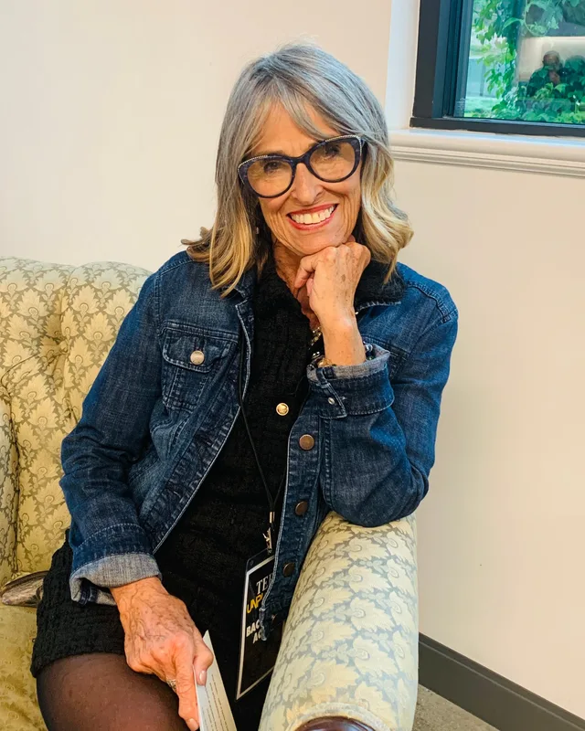 Laura Prince smiling in a denim jacket